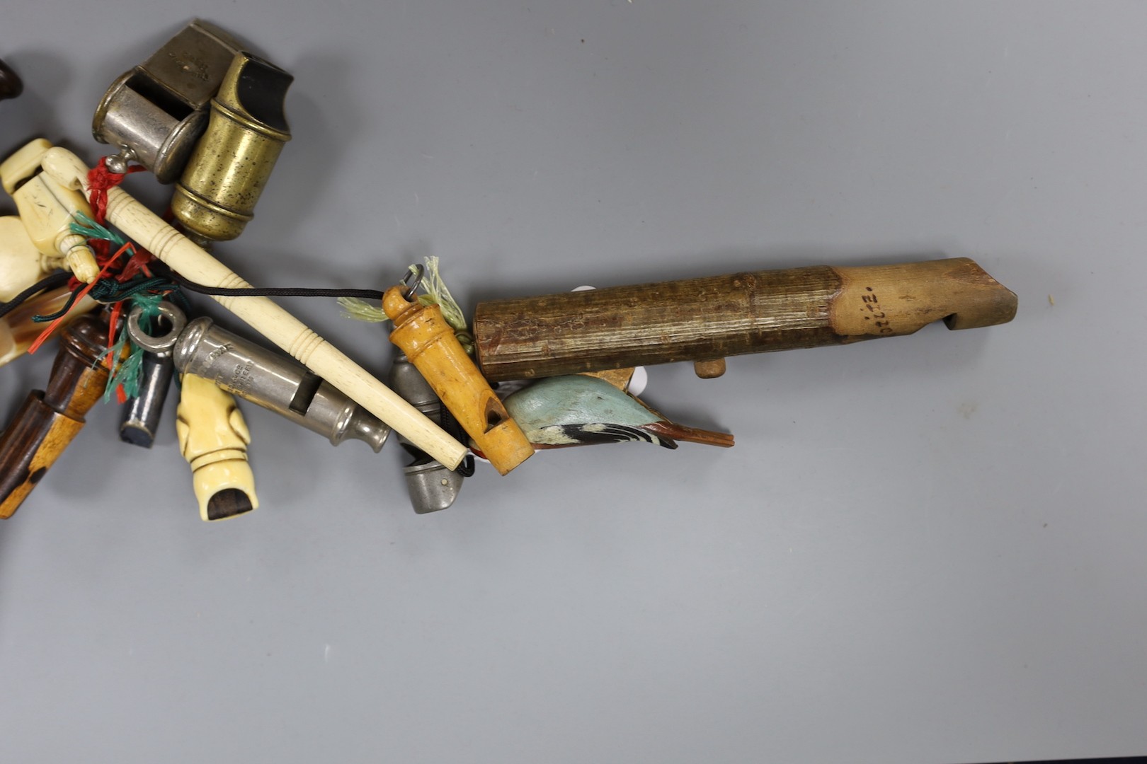 A collection of various collectable 19th century whistles, including bone, pewter, horn, ebony, brass and some ivory.